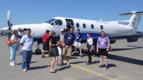 Passengers outside a SeaPort Airlines plane.