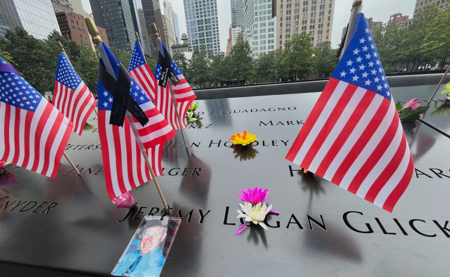 Flags and flowers are placed in the inscribed names at the National September 11 Memorial in New York on Wednesday, Sept. 10, 2025.