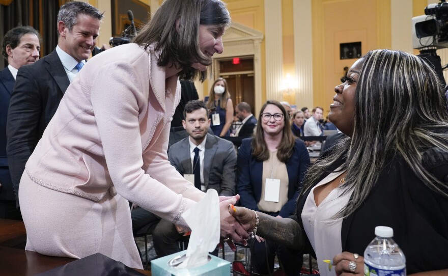 Rep. Elaine Luria, D-Va., greets Wandrea "Shaye" Moss, a former Georgia election worker, after she testified at the House select committee investigating the Jan. 6 insurrection on Tuesday as committee members Reps. Adam Kinzinger, R-Ill., and Jamie Raskin, D-Md., wait their turn.