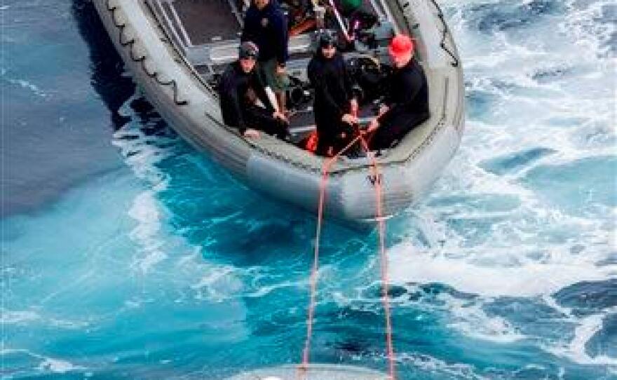 This Wednesday, Feb. 19, 2014 photo released by NASA shows crews testing a test version of Orion's forward bay cover, NASA's next-generation space capsule.