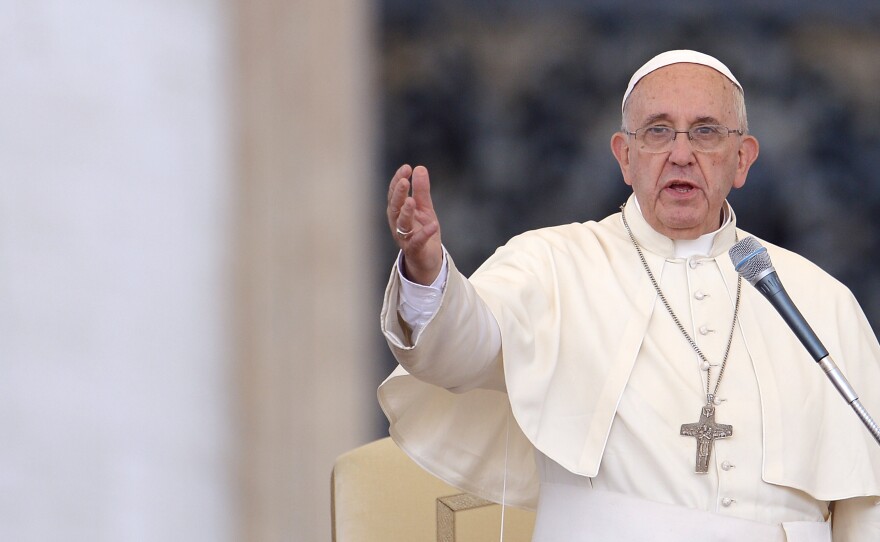 Pope Francis speaks to crowds gathered Sunday in St Peter's square at the Vatican.