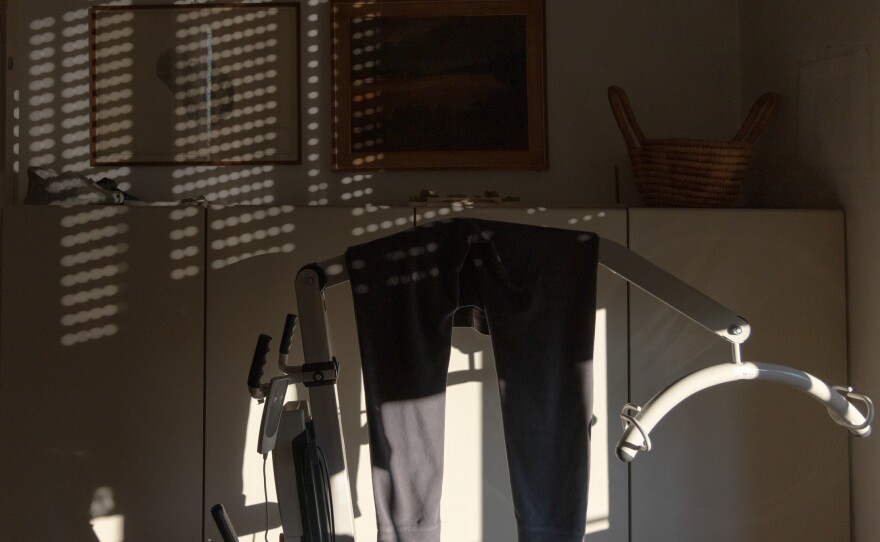 Clothing hangs on a mechanical lifter in Anna's home in Milan in December 2022.