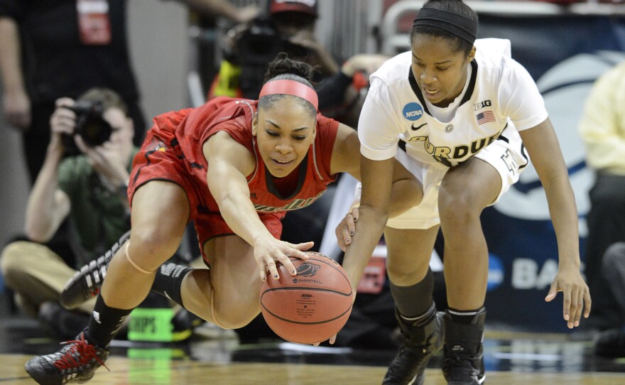 Louisville's Bria Smith, left, battles Purdue's April Wilson for a loose ball during their second-round game in Louisville, Ky., Tuesday.