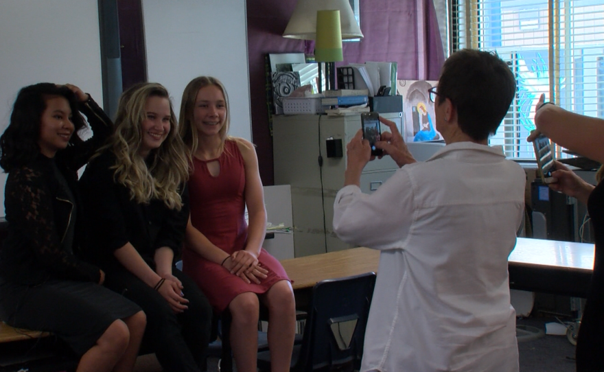 Gloria Hohenstein poses for a photo with her friends after her eighth-grade exit portfolio presentation, May 24, 2017.