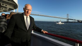 California Gov. Jerry Brown walks to the bow of the high-tech battery-operated San Francisco Bay sightseeing boat, Enhydra, for a cruise of San Francisco Bay, where he signed 16 new laws aimed at easing global warming Thursday, Sept. 13, 2018, in San Francisco. 
