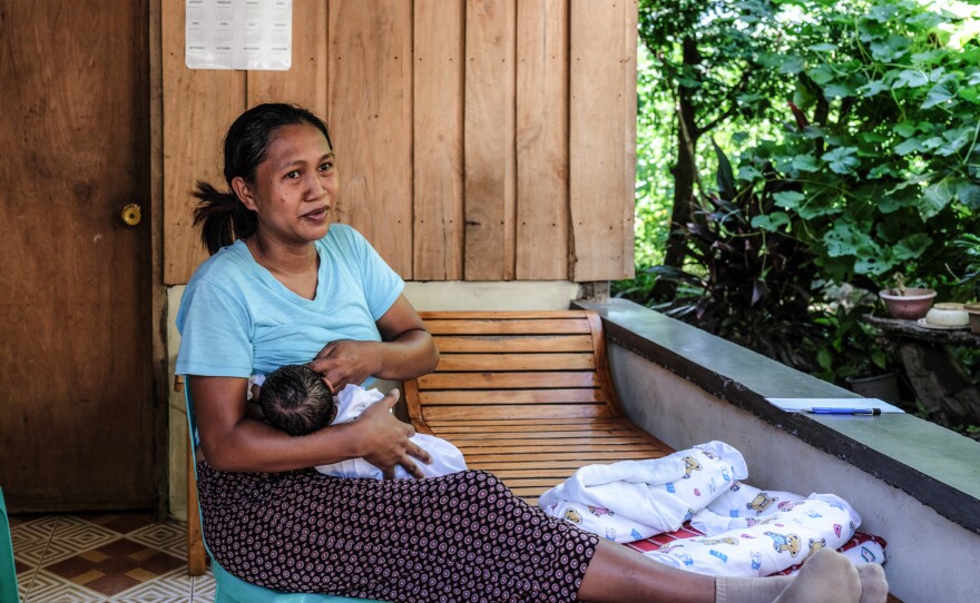 Risa Calibuso breastfeeds her son, Heinrich Claude, in their balcony. He was born on July 27. Calibuso went into labor at home but the local midwife would not participate in a home delivery. Because there were no other options to get Calibuso to the Nueva Vizcaya Provincial Hospital for delivery, the reporter gave her a ride.