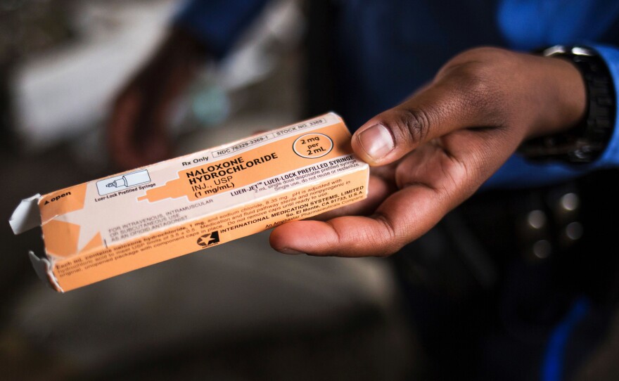 A Philadelphia police officer holds a package of the overdose antidote naloxone while on patrol in the Kensington neighborhood of Philadelphia in April 2017.