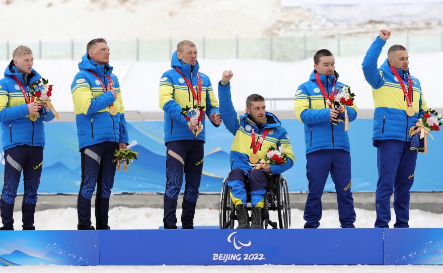 Dmytro Suiarko, Grygorii Vovchynskyi, Vasyl Kravchuk and Anatolii Kovalevskyi of Team Ukraine pose with their gold medals following the para cross-country open 4x2.5km relay during day nine of the Beijing 2022 Winter Paralympics.