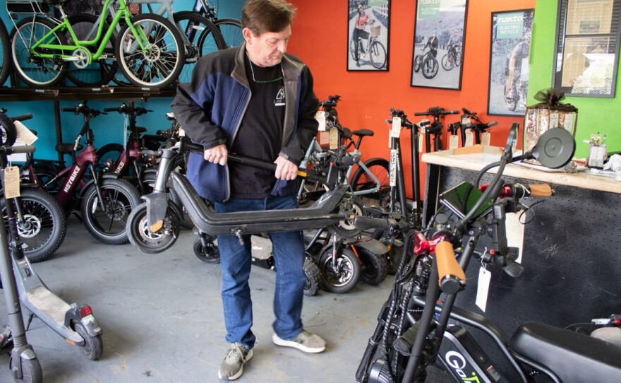 Mike Majors moves an e-scooter Monday, Nov. 17, 2025, at The Electric Bike Shop in Sacramento.