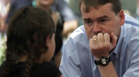 Sen. Michael Bennet (D-CO) visits with a young girl as he campaigns in downtown Colorado Springs, Colo., on Aug. 9. After surviving a tough primary challenge, Bennet is now in a close race with Tea-Party-backed Republican Ken Buck.