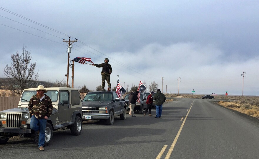 People wave American flags near the Malheur National Wildlife Refuge, near Burns, Oregon, Feb. 11, 2016.