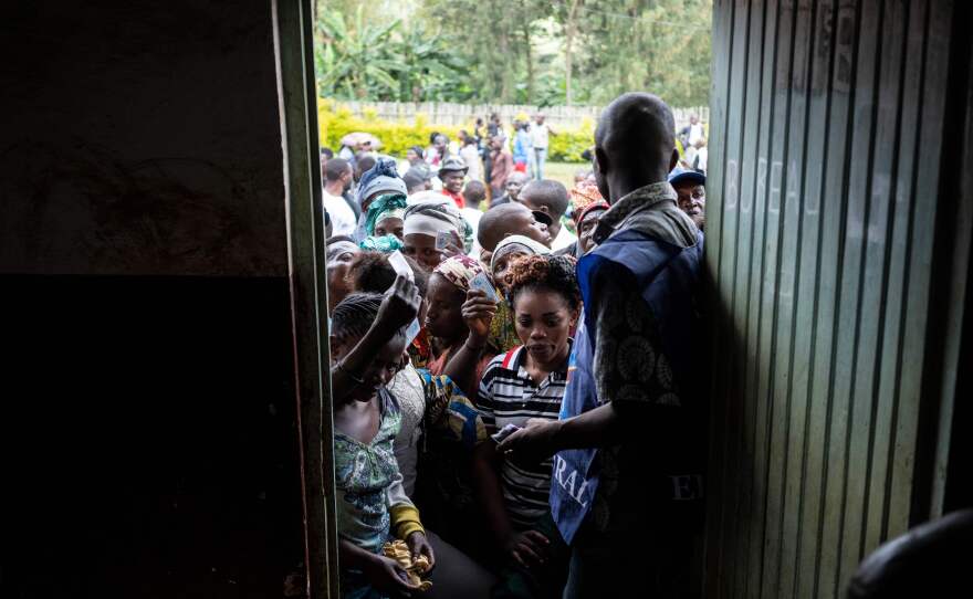 Voters wait to cast their ballot outside a polling station in Democratic Republic of Congo on Sunday.