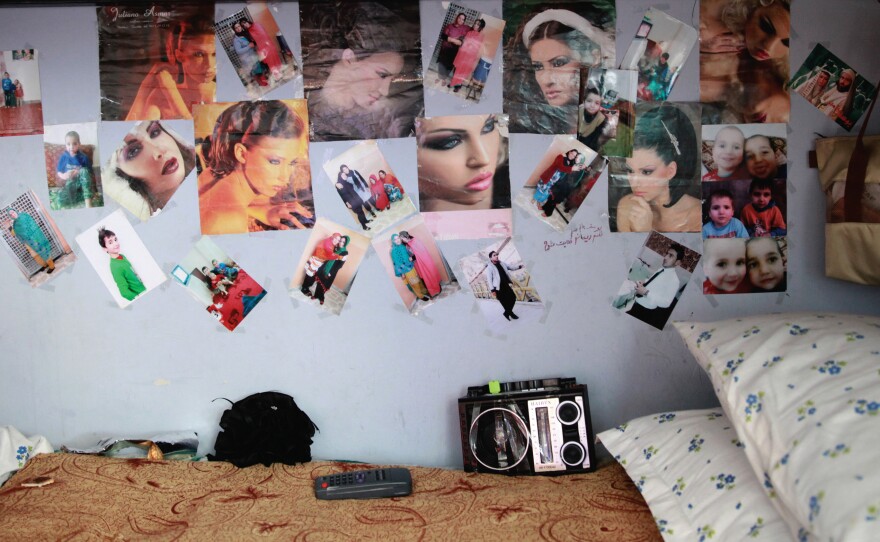 The pages of fashion magazines adorn the walls of a room in the women's prison.