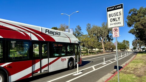 An MTS Rapid 215 bus travels through a bus-only lane on Park Boulevard in Balboa Park, Nov. 21, 2023.