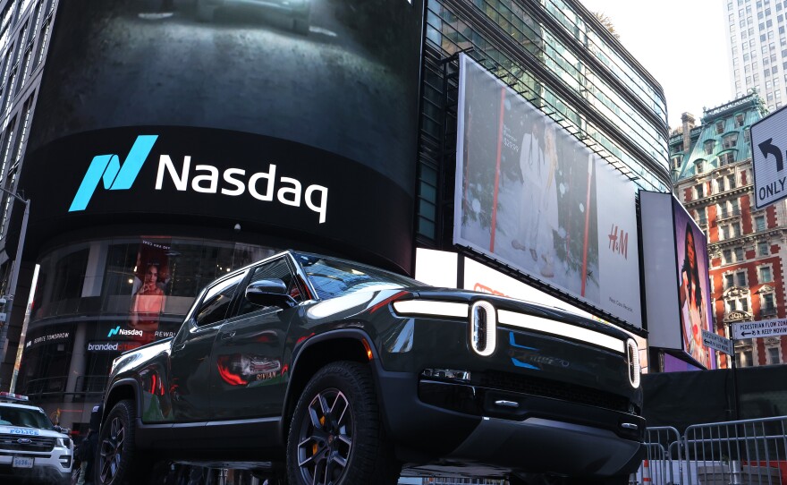A Rivian electric truck is displayed near the Nasdaq MarketSite building in Times Square on November 10, 2021 in New York City. Rivian, an electric truck maker backed by Amazon and Ford, made its debut at Nasdaq in one of the biggest IPOs in U.S. history.