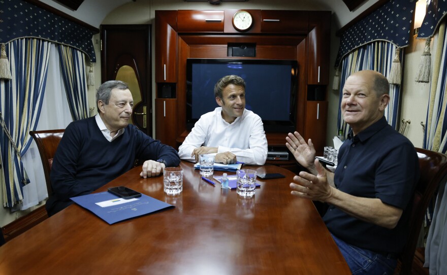 French President Emmanuel Macron (center), German Chancellor Olaf Scholz (right), and Italian Prime Minister Mario Draghi travel on board a train bound to Kyiv after departing from Poland. The three leaders are meeting with Ukraine's President Volodymyr Zelenskyy on Thursday to talk about the war in Ukraine.