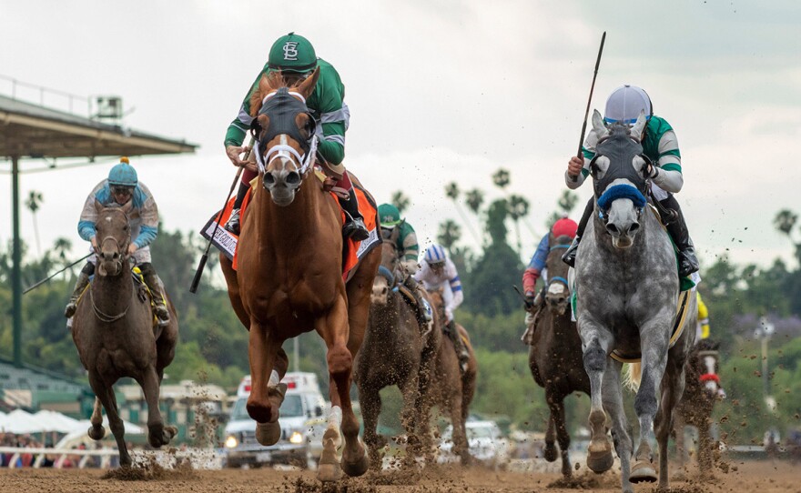 Vino Rosso and jockey John Velazquez, center left, outgame Gift Box with jockey Joel Rosario for victory in the Grade I, The Gold Cup at Santa Anita Park in Arcadia, Calif., Monday, May 27, 2019. They won the Grade I, $500,000 The Gold Cup horse racing.