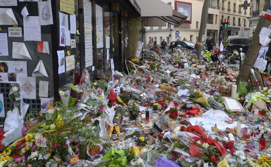 Copies of Ernest Hemingway's book A Moveable Feast are being left at spots in Paris where attackers set upon civilians last week. Here, the Cafe Belle Equipe is seen on rue de Charonne, where flowers and other mementos mark the site.