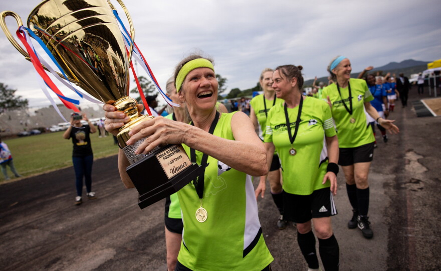 Members of the New England Breakers hoist the trophy after beating the French team "Les Zamies" in a penalty shootout.