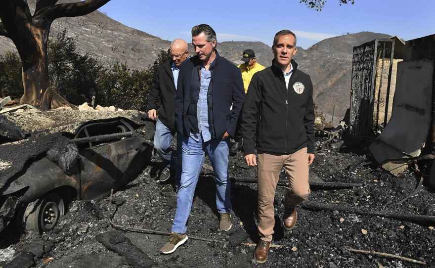 From left, LA City Councilman Mike Bonin, California Gov. Gavin Newsom and LA Mayor Eric Garcetti tour a burned home in Brentwood, Calif., on Tuesday.