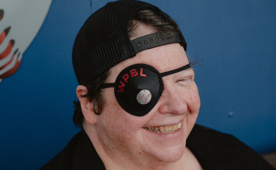 Rebecca Buchanan, of Springfield, Ill., dons a custom eye patch at a WPBL game at Robin Roberts Stadium on Sunday, Aug. 2.