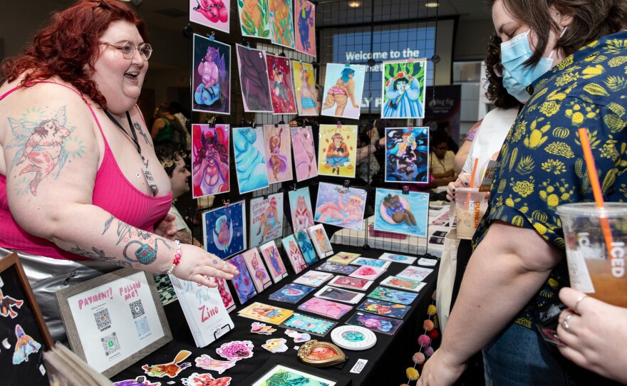 Vendor Ashley Obenstine, who runs 'Obeillustration,' sells their work to attendees at Philly FatCon on Oct. 28. Obenstine was one of the vendors in the marketplace that included people selling art, jewelry, clothing and more.