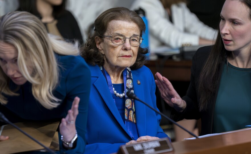 Sen. Dianne Feinstein, D-Calif., is flanked by aides as she returns to the Senate Judiciary Committee on May 11.