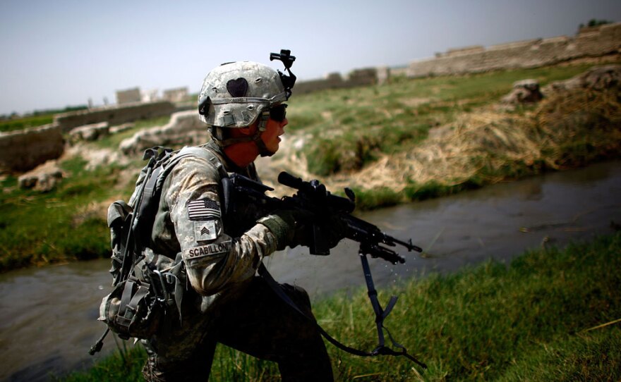 A U.S. soldier runs to take up position while coming under fire near an irrigation ditch in Pashmul, Kandahar province. Many of the leaked reports give a soldier's eye view of the fighting in Afghanistan.