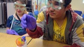 Campers Mary Church and Jimmy Cong use their sense of smell to detect whether a chemical reaction has taken place.