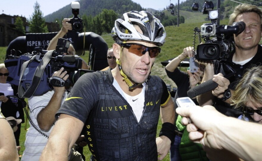 Lance Armstrong finishes the Power of Four Mountain Bike Race on Aspen Mountain on August 25, 2012.