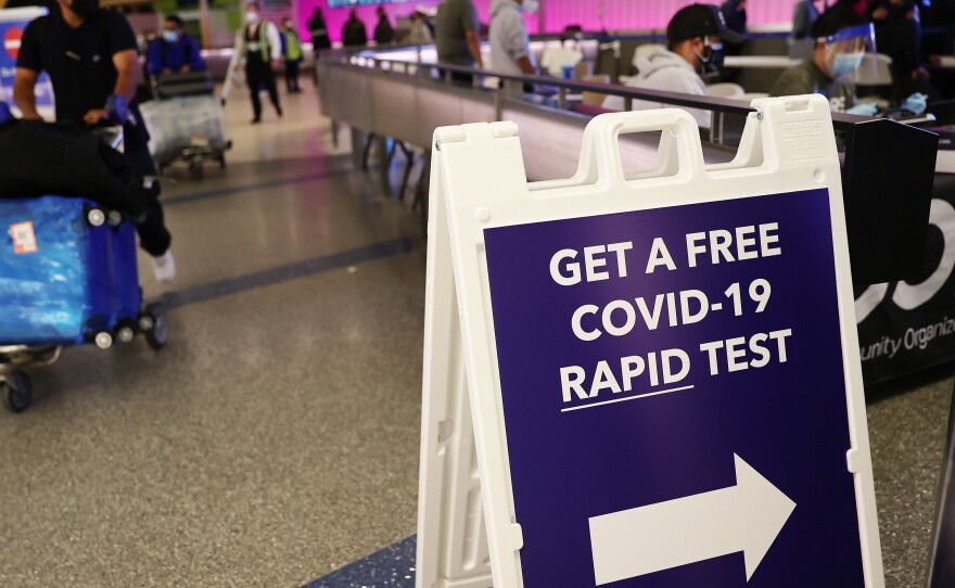 An international passenger arrives near a new rapid COVID-19 testing site for arriving international passengers at Los Angeles International Airport (LAX) on Friday in Los Angeles.