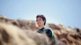 Author Jaimal Yogis holding a surfboard in this undated photo. 