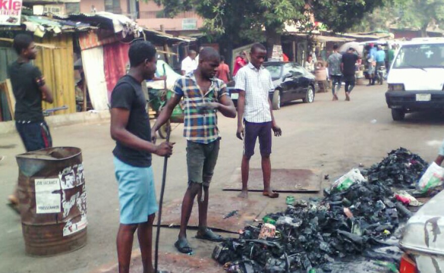 Young volunteers shoveled trash out of a gutter. Sanitation workers later collected the garbage.