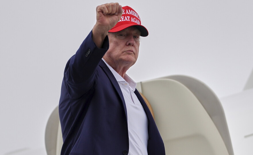 President Donald Trump gestures as he boards Air Force One at Morristown Airport, Sunday, Aug. 16, 2026, in Morristown, N.J.