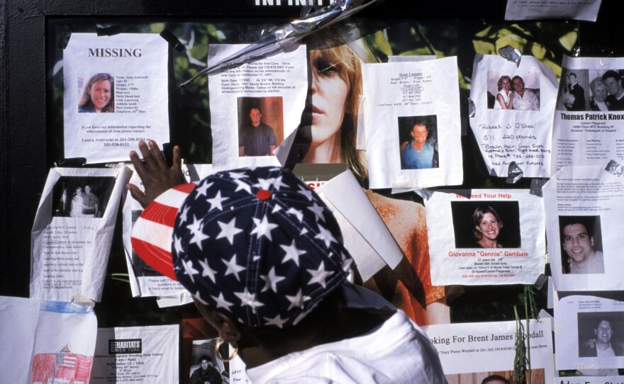 Families and friends leave photos of missing people outside Saint Vincent's Hospital on Sept. 15, 2001.