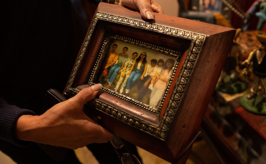 Helen Rivera showing a photo of her with her children in the 1990s. Photographed at their home on May 26, 2019, in Chino, California.