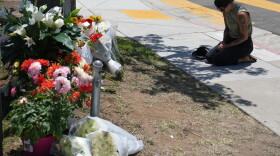 Nicole Witherow prays beside flowers placed outside of the Islamic Center of San Diego on May 19.