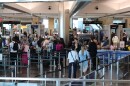 Passengers wait in the Terminal 2 security line at the San Diego International Airport on Monday, March 23, 2026.