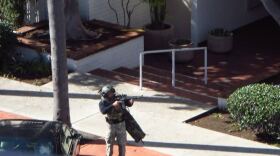 A member of the San Diego police SWAT team responds to an incident at an apartment complex in Bankers Hill, Nov. 4, 2015. 