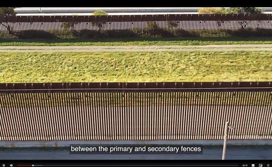 A screenshot from recently released body-worn camera footage shows the primary and secondary fences of the U.S.-Mexico border wall.