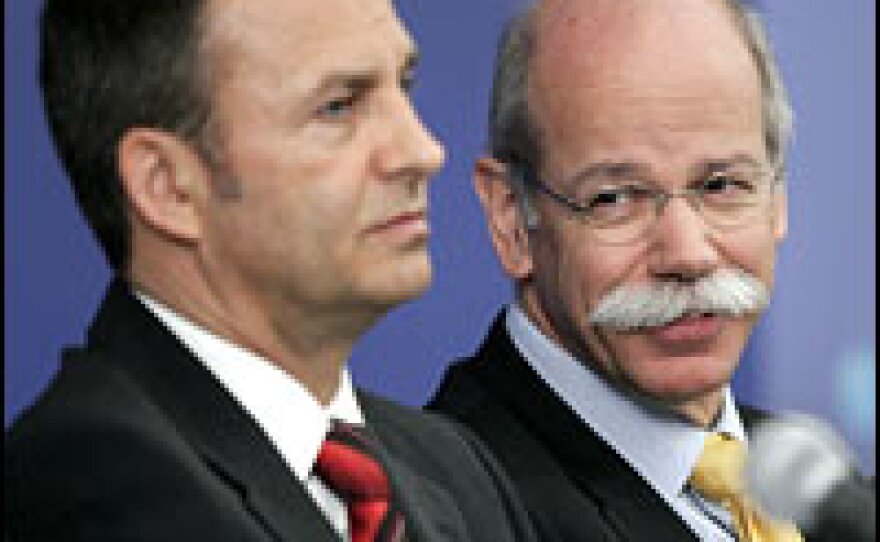 DaimlerChrysler Chairman Dieter Zetsche (right) talks to Chief Financial Officer Bodo Uebber at the auto company's annual board of directors' press conference in Auburn Hills, Mich., Feb. 14, 2007.