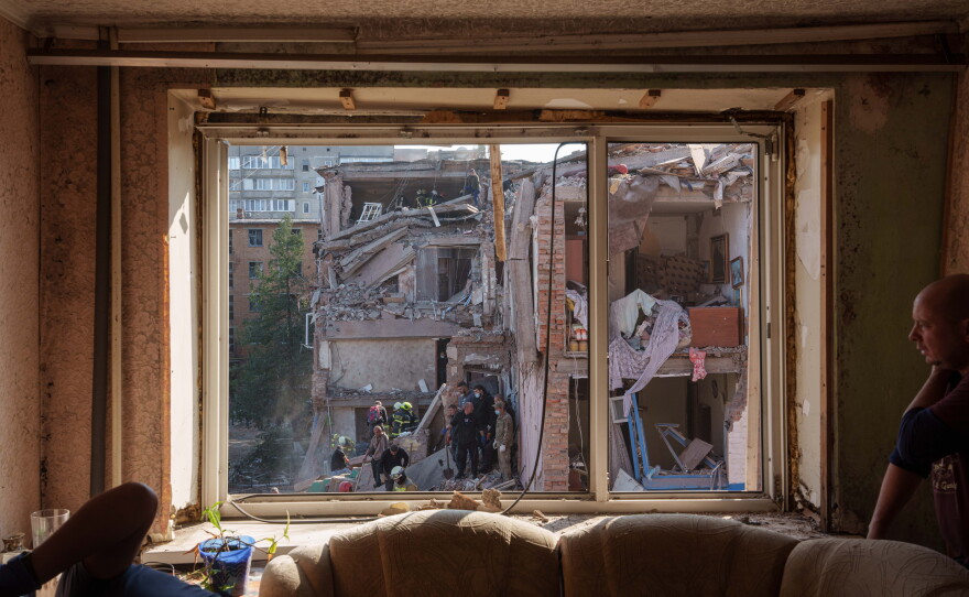 Locals and rescuers clear the rubble of a residential building destroyed in a Russian missile strike on Pryluky, Ukraine, Wednesday, Oct. 7, 2026.