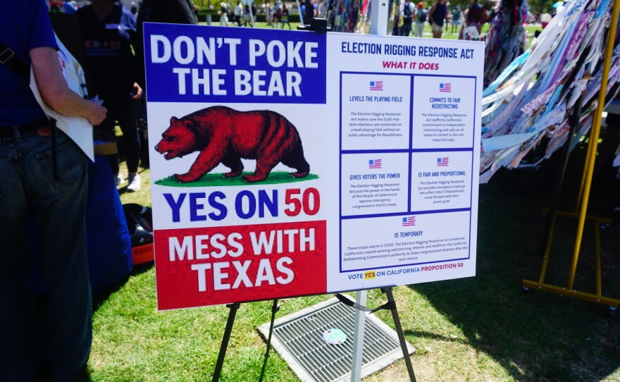Supporters of a plan to redraw California's congressional districts ahead of the 2026 general election display a sign outside of the San Diego County administration building on Sep. 1, 2025 in San Diego, Calif.