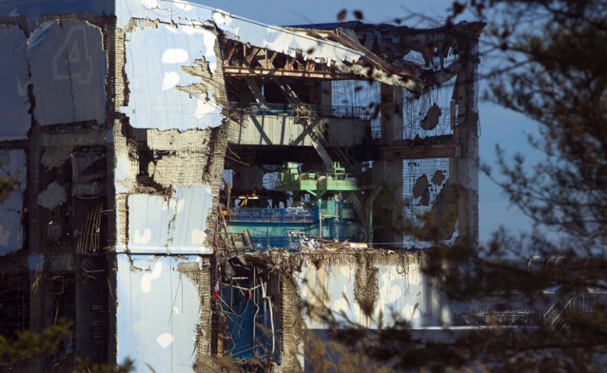 The crippled Fukushima Dai-ichi nuclear power station is seen through a bus window on Nov. 12. The four reactors that failed were stabilized this month.