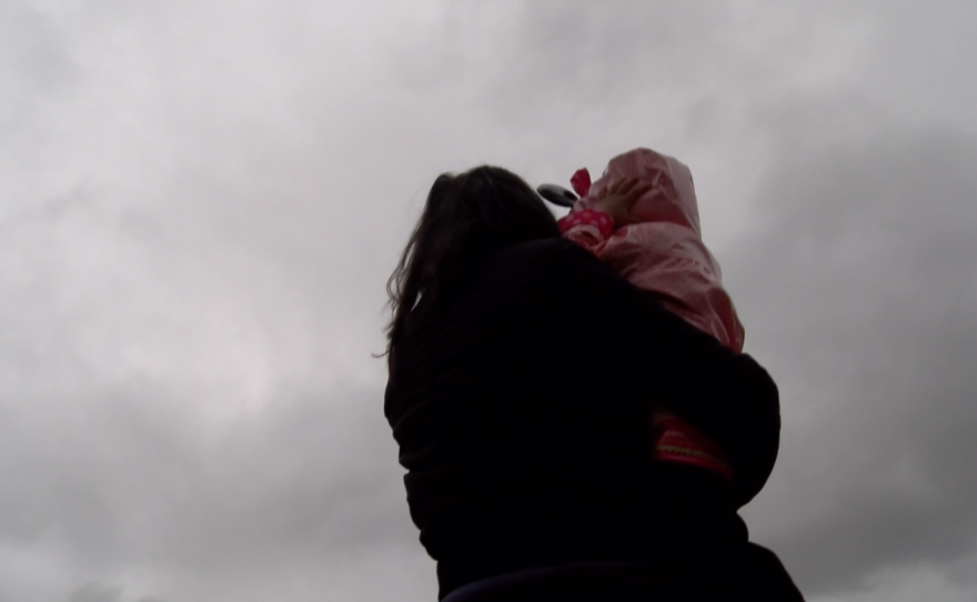A San Diego immigrant, Marina, shows a little girl the sky, Jan. 22, 2016.