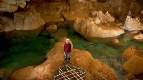 Alexander Kendrick stands in the Lake of the Clouds after testing his invention. He and the team of cavers executed the deepest known digital communication ever to take place in the United States.