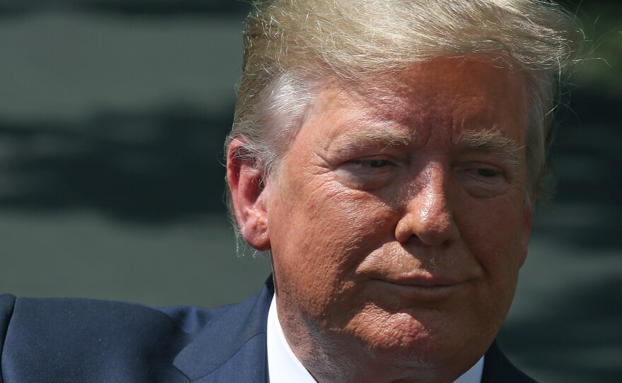 President Trump speaks to reporters outside the White House on Wednesday before departing for Kentucky.
