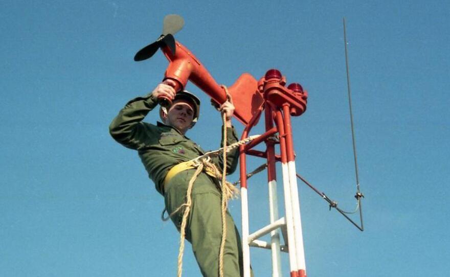 Lynn Eldredge started his working life in the Air Force in 1985. Here, he's installing a wind speed and direction transmitter.