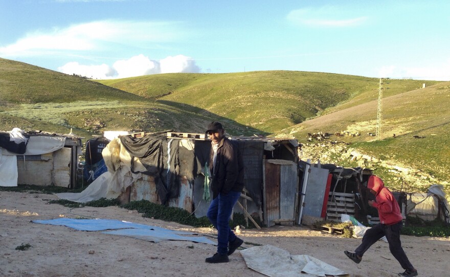 Eed Khamis, a Palestinian Bedouin, walks in an encampment in the Jordan Valley. He says Israelis diverted water supplies to serve nearby Jewish settlements, until Bedouins hammered holes in the pipes for access.