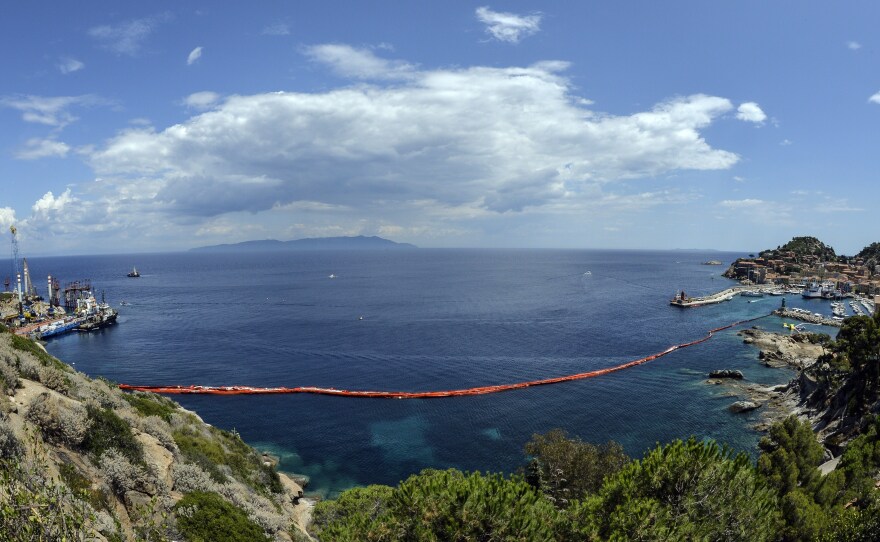 The harbor of the Italian island of Giglio, after the wreck of the Costa Concordia was towed away. Italy's once-luxurious cruise liner embarked on its last voyage on Wednesday.